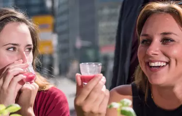 Two women trying a smoothie