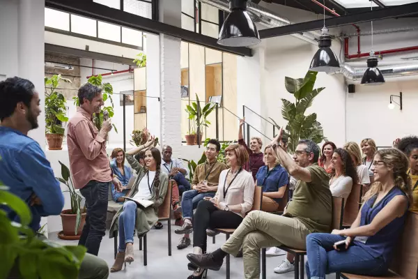 Interactive business meeting in a relaxed atmosphere with plants in the background